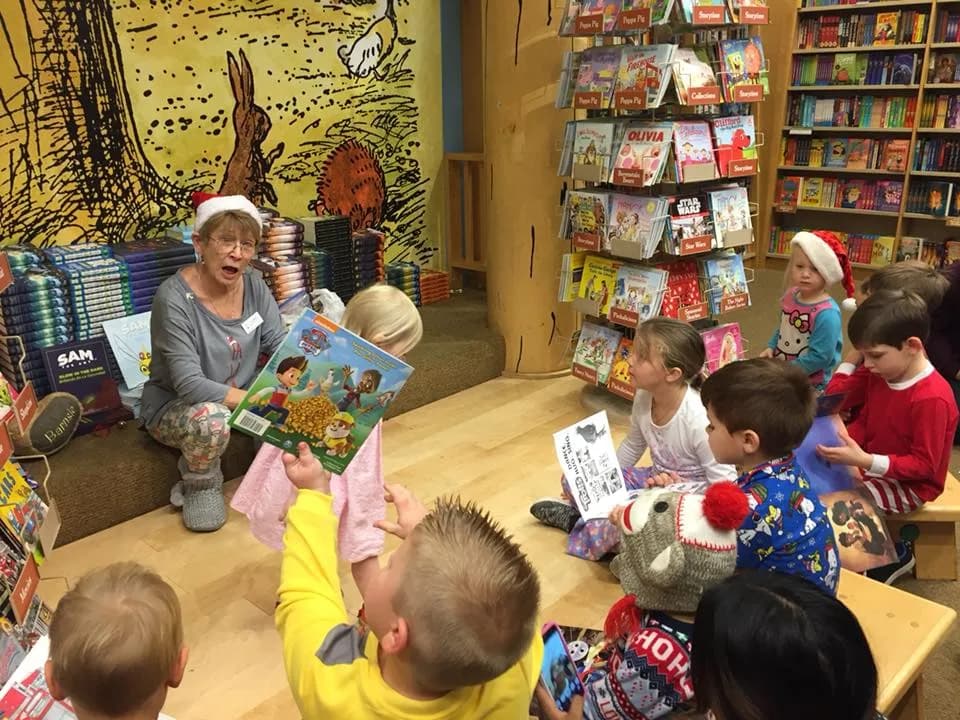 A child reading a new book while wearing cozy new pajamas