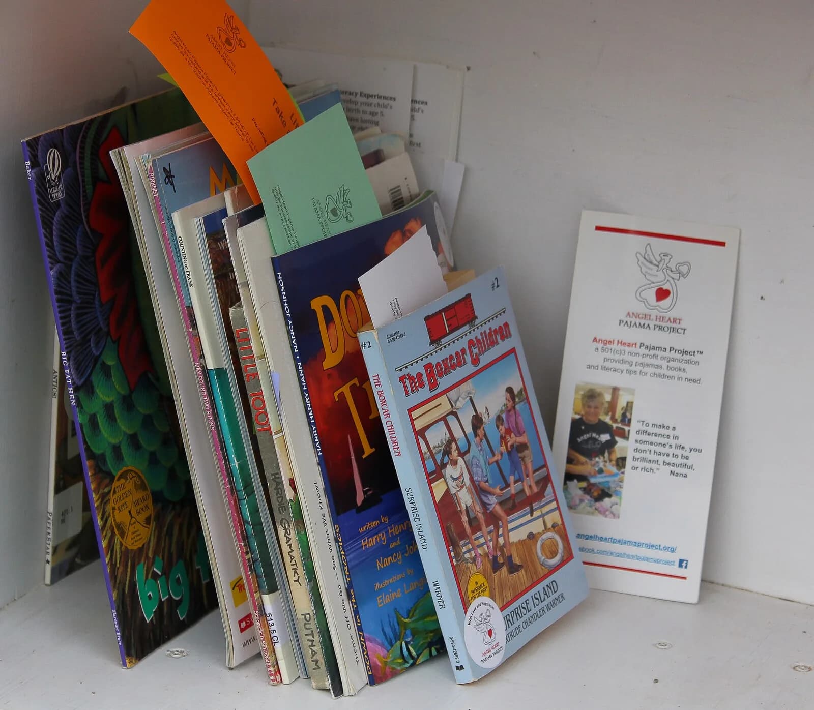 Children choosing books from an Angel Heart Little Free Library