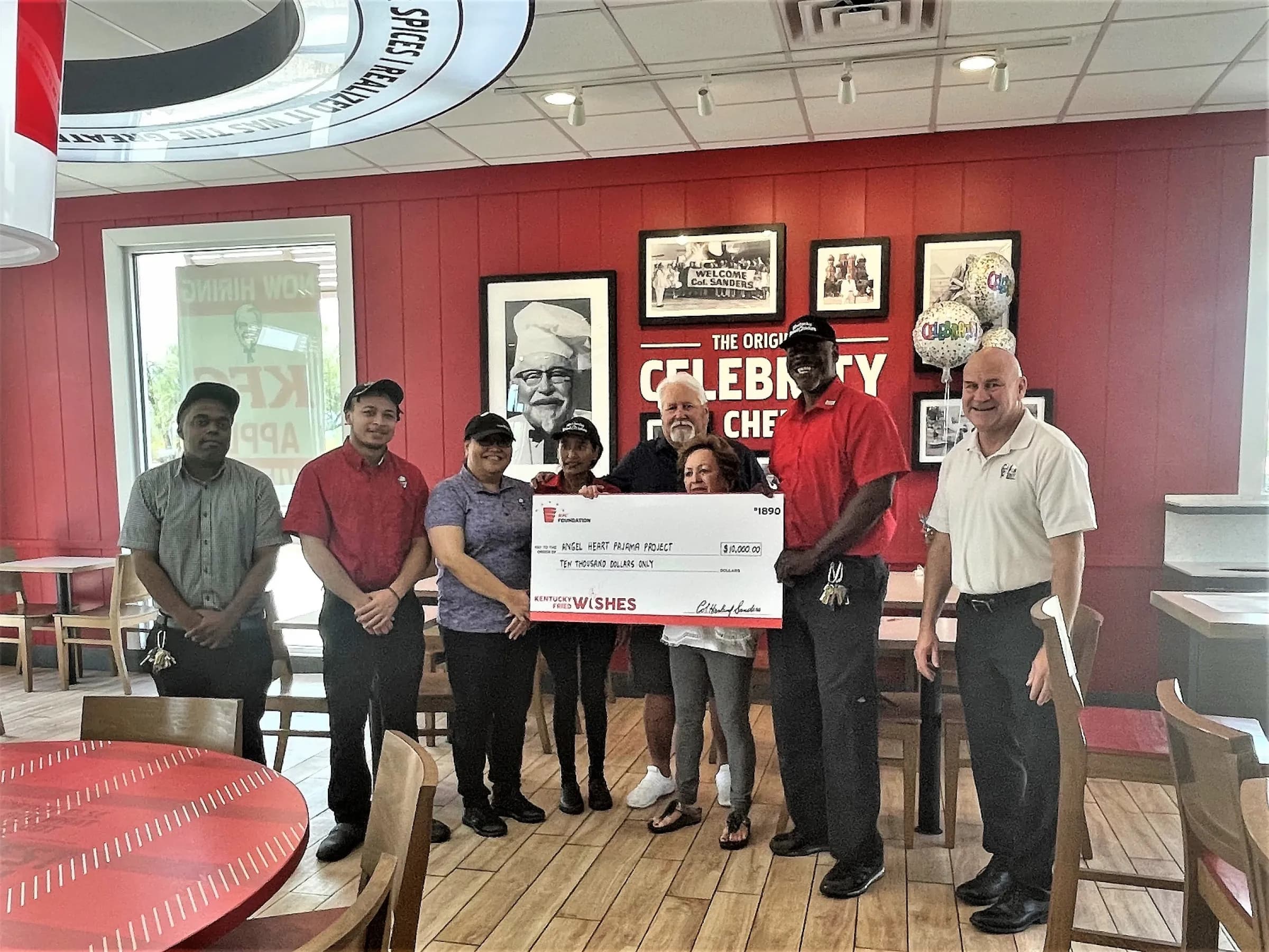 Angel Heart representatives receiving a ten thousand dollar grant check from the KFC Foundation