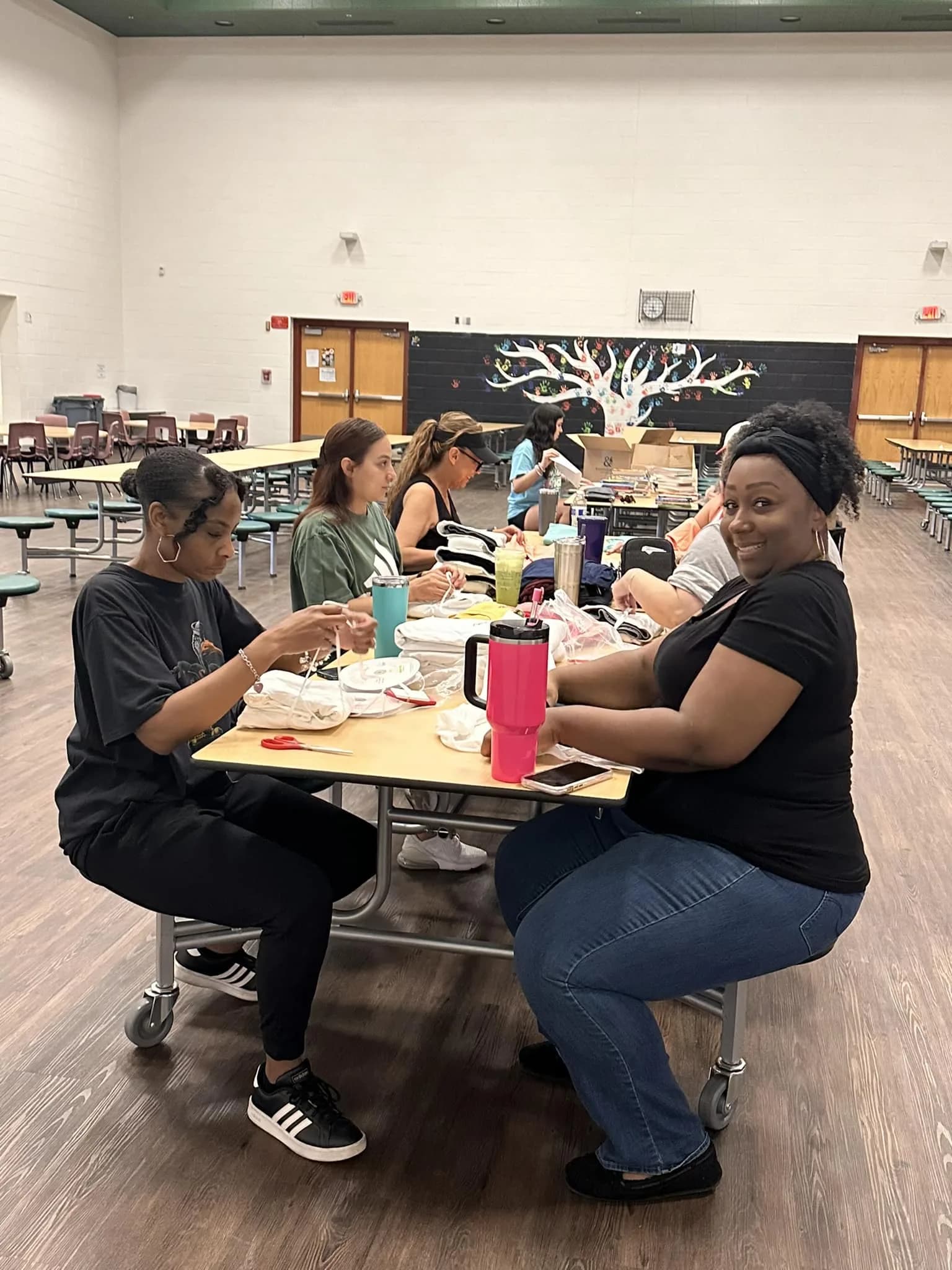 Volunteers preparing pajamas and books for children in need