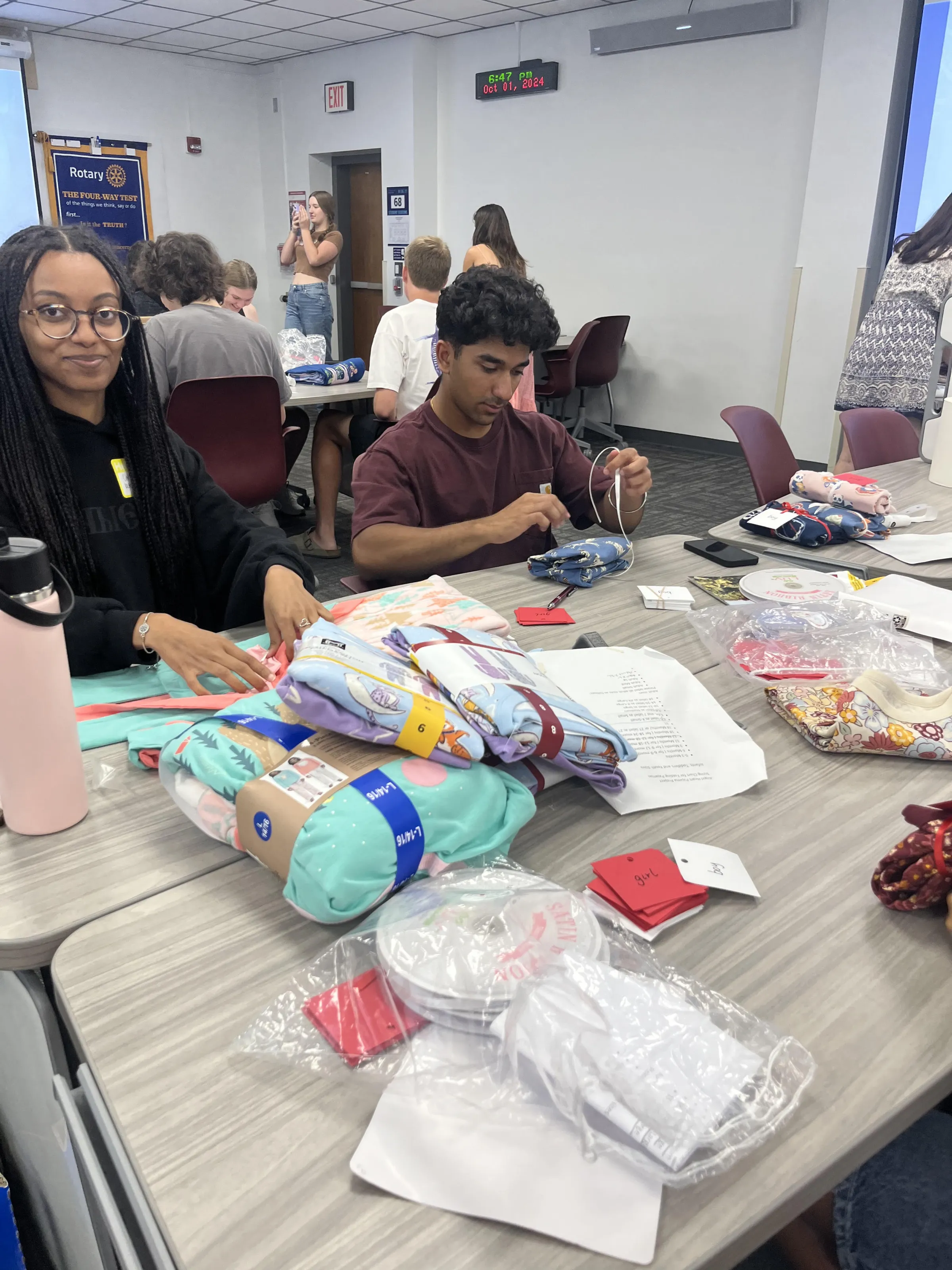 Children receiving new pajamas and books at an Angel Heart event