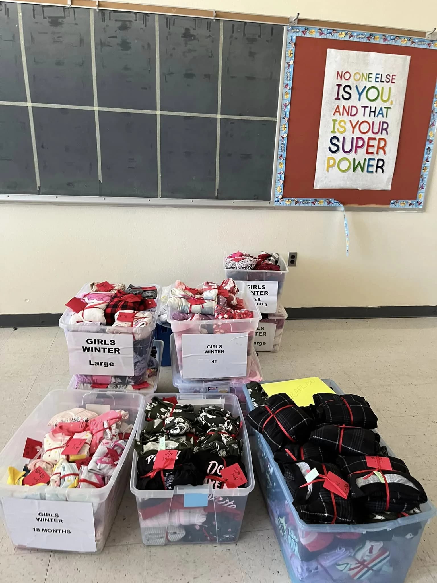 Bins of new pajamas sorted by size and ready for delivery to children