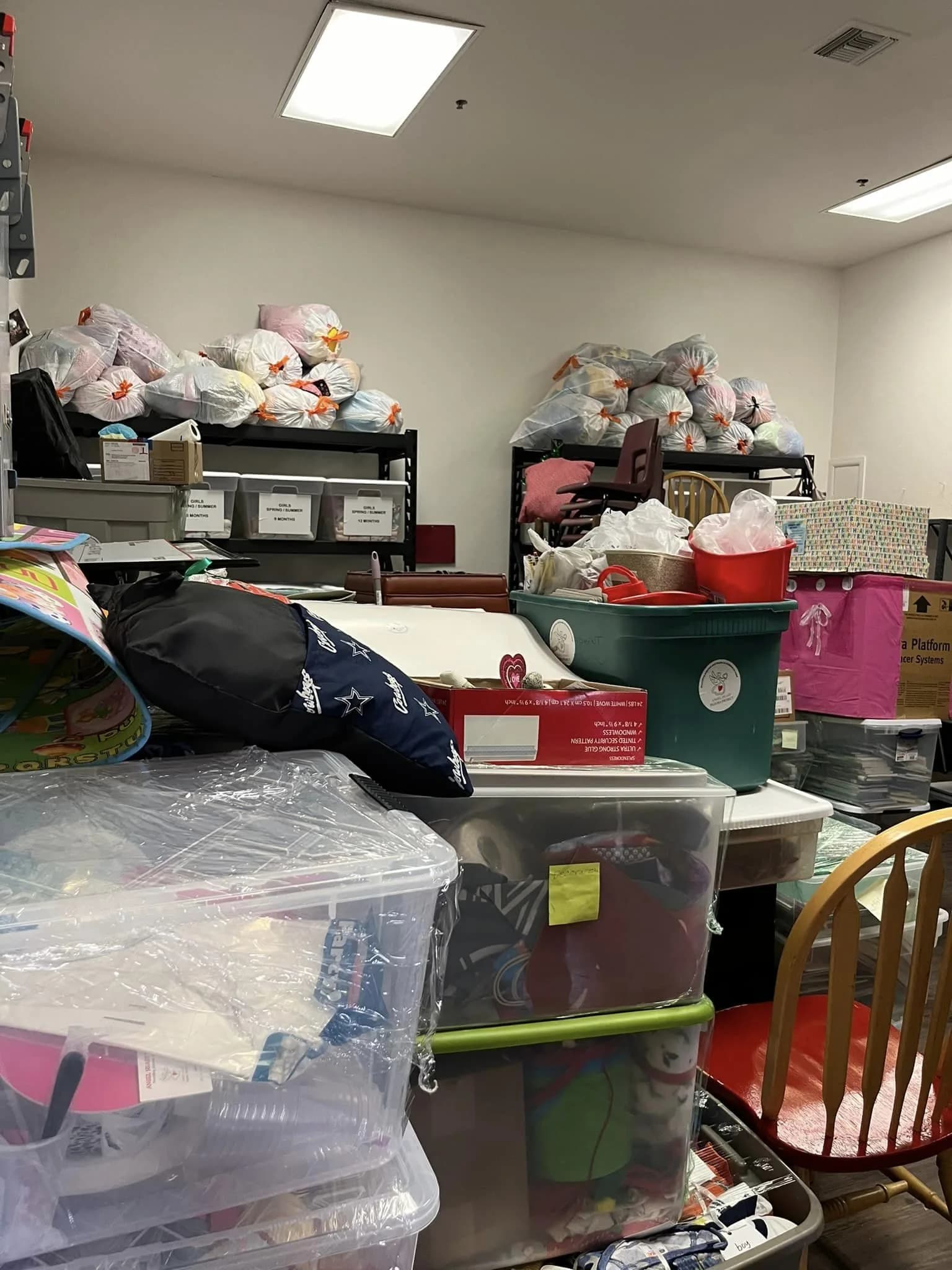 Volunteers boxing up new books and pajamas in the Angel Heart storeroom
